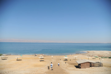 Fototapeta na wymiar Dead Sea, Amman Beach,Jordan - September 28: vacationers and tourists bathe in the Dead Sea with Dead Sea mud in Amman Beach, Jordan