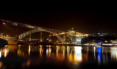 Fototapeta na wymiar Night bridge reflection over river in Porto Portugal