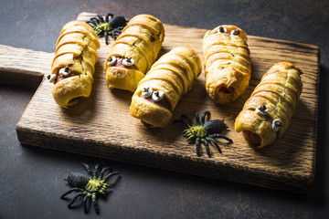 Halloween food. Scary sausage mummies in dough.