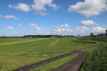 Fototapeta premium meadows of the Zuidplaspolder at Moordrecht, the lowest area of western europe in the Netherlands in wide area view with blue sky and white clouds.
