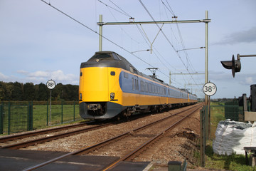 Fototapeta premium Intercity train at railroad track between Gouda and Rotterdam at Moordrecht.