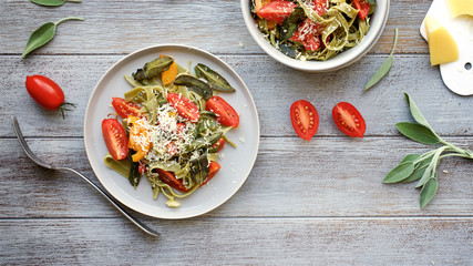 Pasta tagliatelle with fried sage and tomatoes. Top View Served Table
