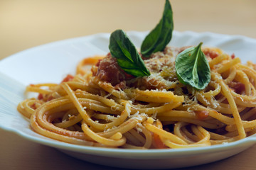 Plate of tomato and basil spaghetti.