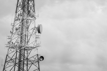 Abstract telecommunication tower Antenna and satellite dish with sunset sky background.