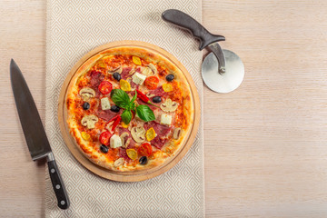Pizza with Mozzarella, Ham, Cherry Tomatoes, Black Olives
