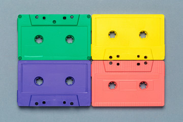 Bright retro cassette tapes on a light grey background