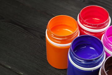 paint bottels on rustic wooden background