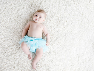 Adorable baby girl on white background wearing turquoise tutu skirt. © Irina Schmidt