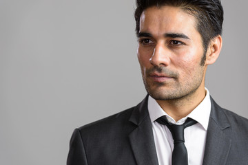 Young handsome Persian man against white background