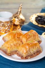 Oriental sweets, baklava, sherbet on a blue background
