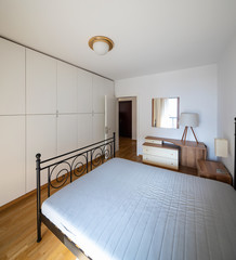 Bedroom with parquet and large wardrobe