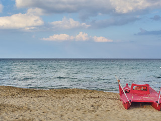 Shot of the beautiful tropical San Lorenzo beach near Syracuse in a sunny day of summer, with a lifeguard boat parked on the seaside