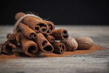 Cinnamon sticks on wooden background.