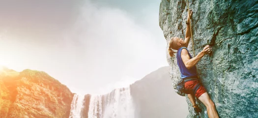 Foto auf Acrylglas rock climber climbing the challenging route on the limestone wall © vitaliymateha