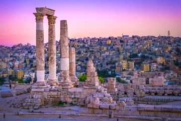 Wall murals Old building Amman, Jordan its Roman ruins in the middle of the ancient citadel park in the center of the city. Sunset on Skyline of Amman and old town of the city with nice view over historic capital of Jordan.