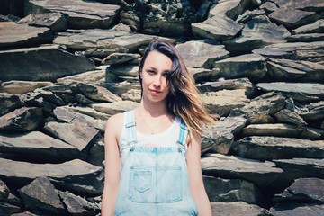 Portrait of a girl on the background of sharp stones