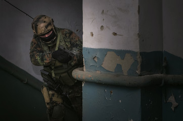 A army soldier takes aim with a pistol gun in his hands. Storming the building concept.