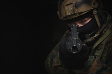 A army soldier takes aim with a rifle in his hands to the screen. Storming the building concept....