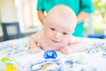 Doctor masseur wearing uniform massaging little baby