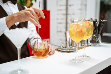 Bartender making cocktails at the party.