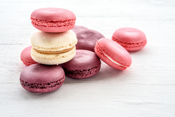 Sweet macarons on a white  background. Trendy cakes.