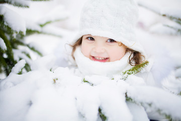 Toddler girl walking outdoors, snowy winter