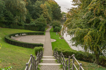 Wooden benches on the banks of the river Trave in Lübeck, Germany