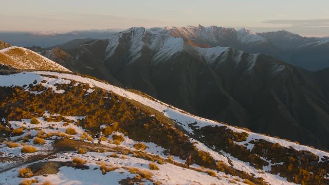 Two hikers on top of peak, Roys Peak, New Zealand South Island
