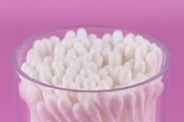 Cotton buds on a pink background. Selective focus