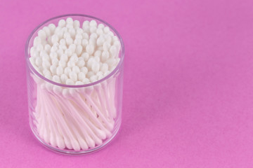 Cotton buds on a pink background. Selective focus