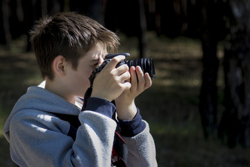 Portrait of a young photographer shooting a landscape