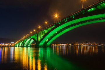 Fototapeta na wymiar Reflection of the Communal Bridge in the Yenisei river, Krasnoyarsk, Russia. Urban landscape