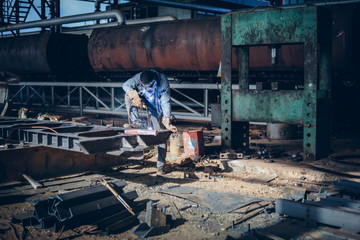 Fototapeta na wymiar Industrial Welding Workers Make Welding in a Factory