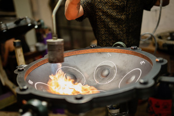 Artisan constructing handpan