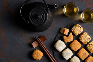 Mochi assortment with wooden chopticks and tea traditional japanese rice dessert flat lay top view