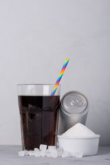 Soft drink and can with and crystal sugar on table