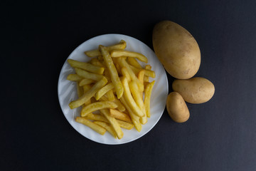 Potato fry on dark background with selective focus and crop fragment