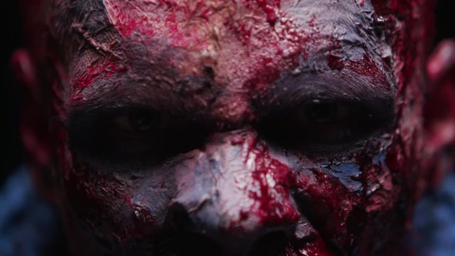 Zombie Maniac is scary of his teeth trying to bite the dark background of darkness