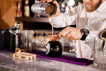Bartender bartender is pouring a drink. Alcoholic drink
