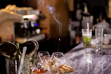 Aromatic smoke sticks on bar counter.