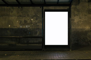 Light box display with white blank space for advertisement at bus station in night city. Mock-up...