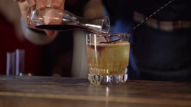 Barman prepares alcoholic cocktail