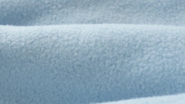 Close-up of blue blanket made of polar fleece 4K panning video