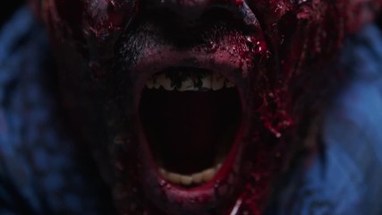 Zombie Maniac is scary of his teeth trying to bite the dark background of darkness