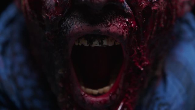 Zombie Maniac is scary of his teeth trying to bite the dark background of darkness