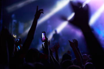 the guys put their hands up and enjoy the music. crowd at concert - summer music festival.