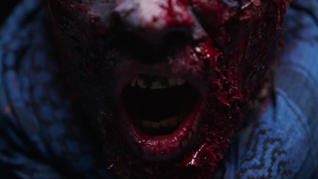 Zombie Maniac is scary of his teeth trying to bite the dark background of darkness