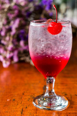 Close up Strawberry Italian soda with cherry,Bouquet of dried flowers background.