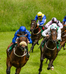 Speeding race horses and jockeys competing