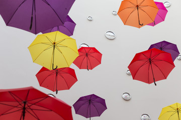 Conceptual installation of abstract background of beautiful colored umbrellas indoors.